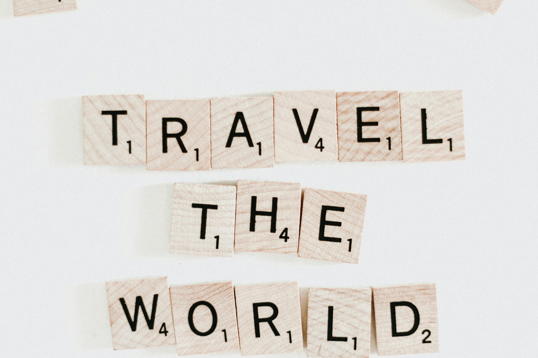"TRAVEL THE WORLD" spelled with the scramble game letters